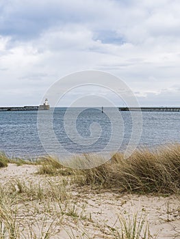 Beach at Blyth, Northumberland, UK with pier, lighthouse and copy space