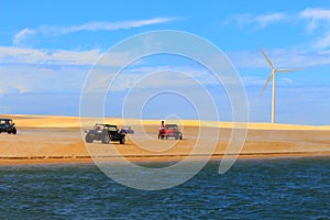 Beach buggies and Wind turbine on Dunes / Galinhos, Brazil