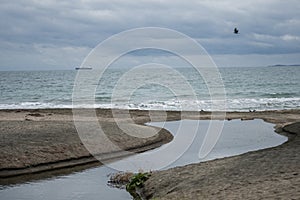 A beach in Bulgaria. A river naturally formed on the sand. Black Sea.