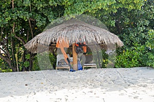 Beach cabana with chairs have snorkeling equipment and other valuables left unattended. Taken in the Maldives