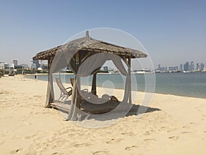 Beach cabana with the Doha skyline in the background