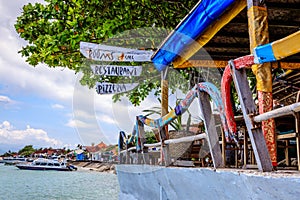 Beach cafe with outriggers from old traditional Indonesian longtail boats as handrails Nusa, Lembongan, Indonesia