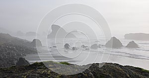 The beach is calm and peaceful with a few rocks scattered around