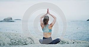 Beach, calm and woman doing a yoga exercise for calm mindset, wellness and health. Nature, meditation and back of female