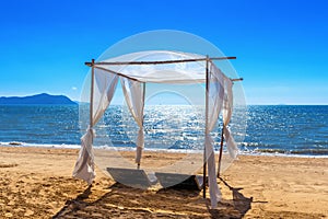 Beach canopies with sun loungers on beach