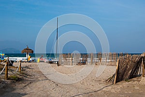 Beach and catamaran in Can Picafort, Spain