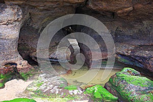 Beach cave cleft at low tide