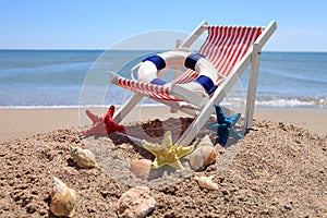 Beach chair near the ocean with shells