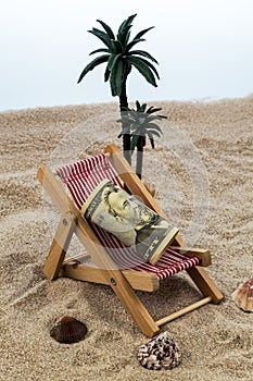 Beach chair with piggy bank and dollars