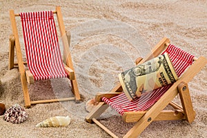 Beach chair with piggy bank and dollars