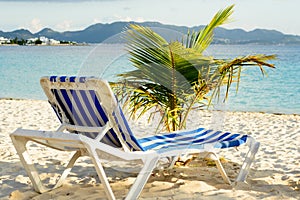 Beach chair on Rendez-vous beach in Anguilla, with a view of St Martin island