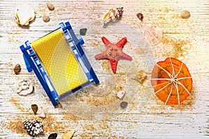 Beach Chair, Shells, Sand on white wooden board background