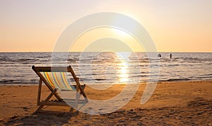 Beach chair on the tropical beach at sunset time