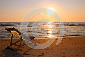 Beach chair on the tropical beach at sunset time