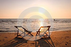 Beach chair on the tropical beach at sunset time