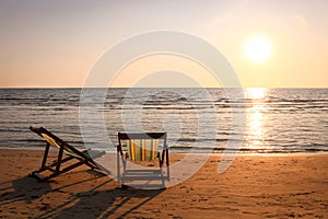 Beach chair on the tropical beach at sunset time