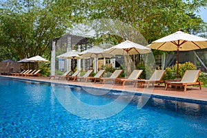 Beach chair and umbrella side the pool