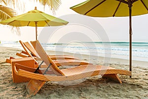 Beach chair under the big umbrella and was on the beach. Beautiful beach. Chairs on the sandy beach near the sea.