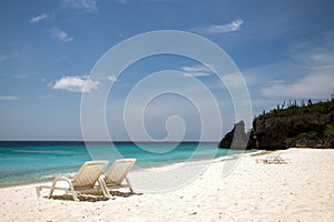 Beach chairs and an azure blue sea