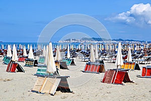 Beach chairs, beds and umbrellas on the Albanian beach before summer holiday season. Golem, Durres, Albania