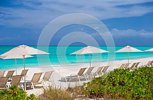 Beach chairs on exotic tropical white sandy beach