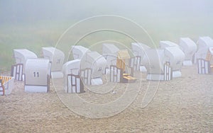 Beach chairs at fog