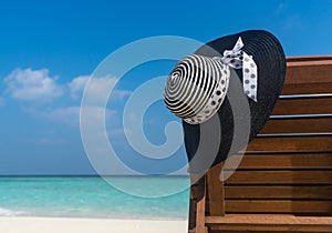 Beach chairs with hat on white sandy beach