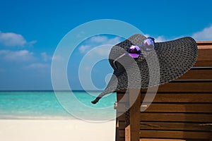 Beach chairs with hat on white sandy beach