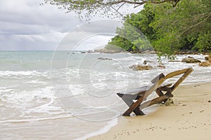Wooden canvas chair on a beautiful tropical beach photo