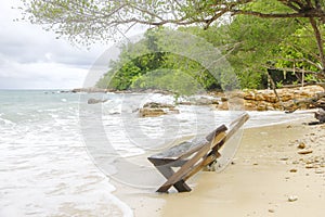 Wooden canvas chair on a beautiful tropical beach photo