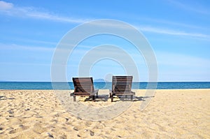 Beach chairs on sand beach. Concept for rest, relaxation, holidays, spa, resort with copy space area.