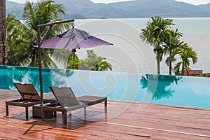 Beach chairs by the swimming pool with beautiful sea view