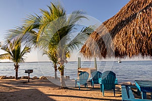 Beach chairs and tiki hut on the shore