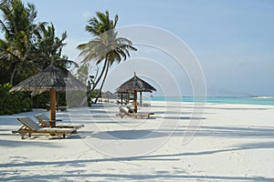Beach chairs in tropical beach in Maldives, Indian Ocean.