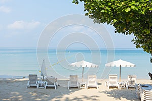 Beach chairs with umbrella with blue sky