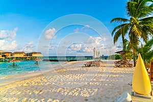 Beach chairs with umbrella at Maldives island, white sandy beach