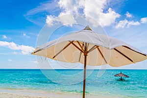 Beach chairs with umbrella at Maldives island, white sandy beach