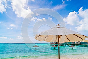 Beach chairs with umbrella at Maldives island, white sandy beach