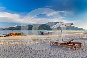 Beach chairs, umbrella and palms on the beautiful beach for holidays and relaxation at Koh Lipe island, Thailand