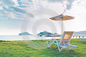 Beach chairs and beach umbrellas are on the lawn at the beach.Sea view,