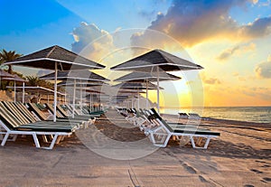 Beach chairs and umrellas at dawn