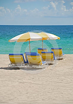 Beach chairs under umbrellas