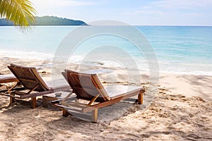 Beach chairs on the white sand beach with blue sky and sun