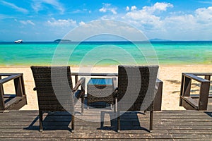 Beach chairs on the white sand beach at summer terrace restaurant