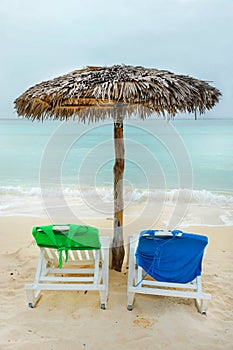 Beach chairs and a straw hut on the Cuban beach photo