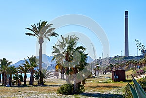 Beach and chimney of cement factory in Carboneras. Spain