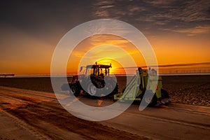 Beach cleaning at sunrise on the east coast of England.