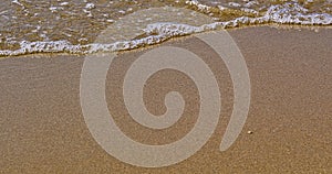 Beach close up on sand and sea water