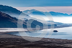 Beach or coastline with misty mountains in the background