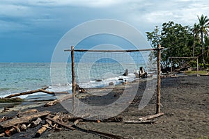 beach of Cocles on the Caribbean side of Costa Rica, Puerto Viejo de Talamanca with an handmade soccer coal made of palm trees photo